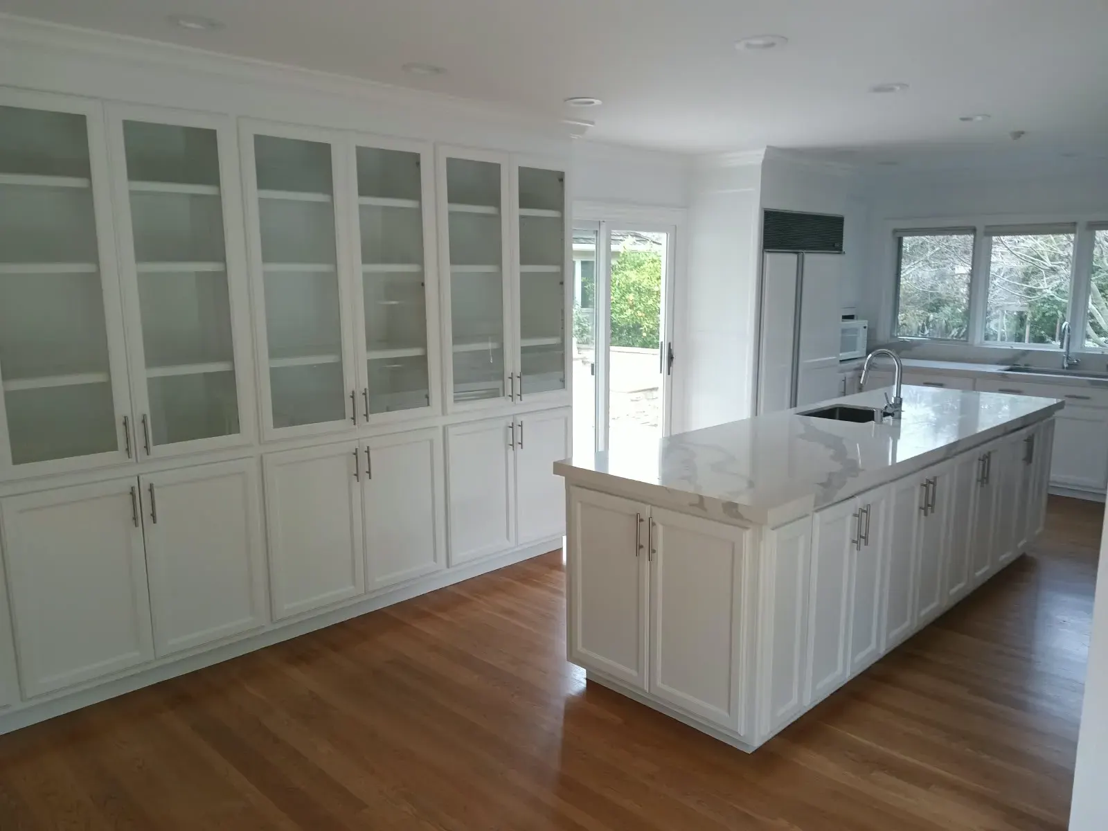Cabinet painting in San Jose, CA: white kitchen with glass-front cabinets