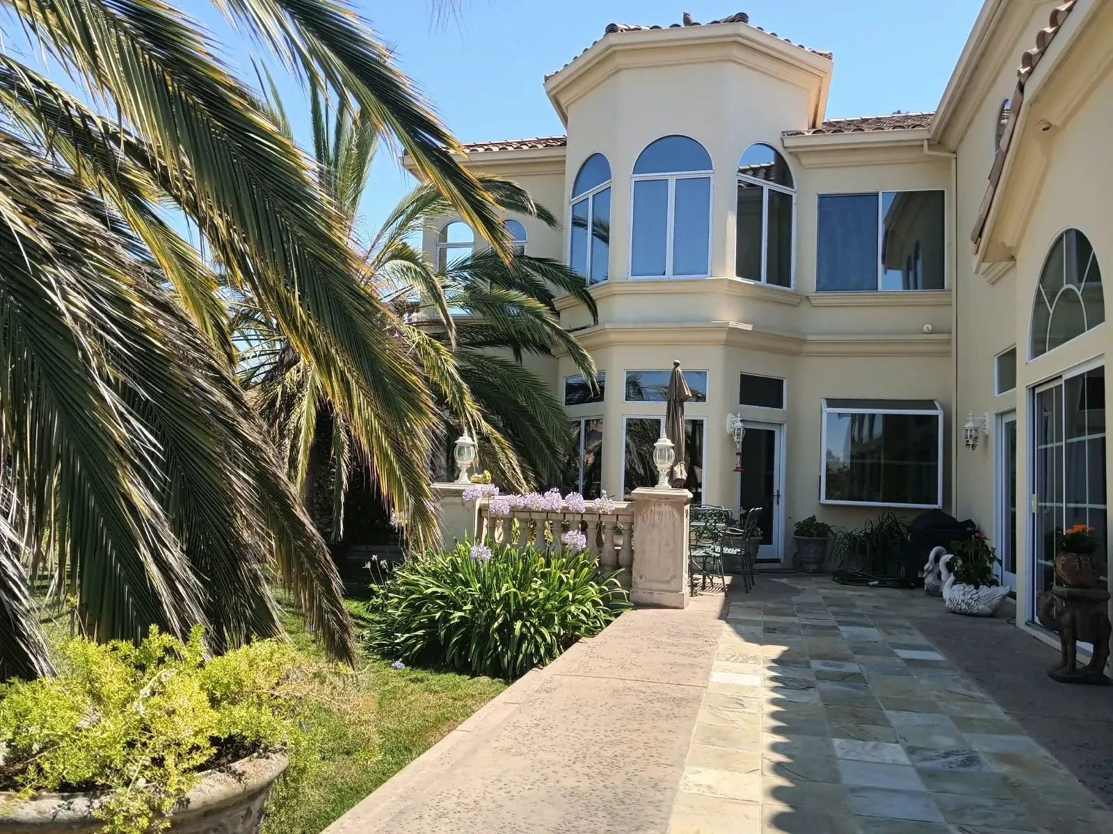 Exterior painting in San Jose, CA: large stucco home with arched windows