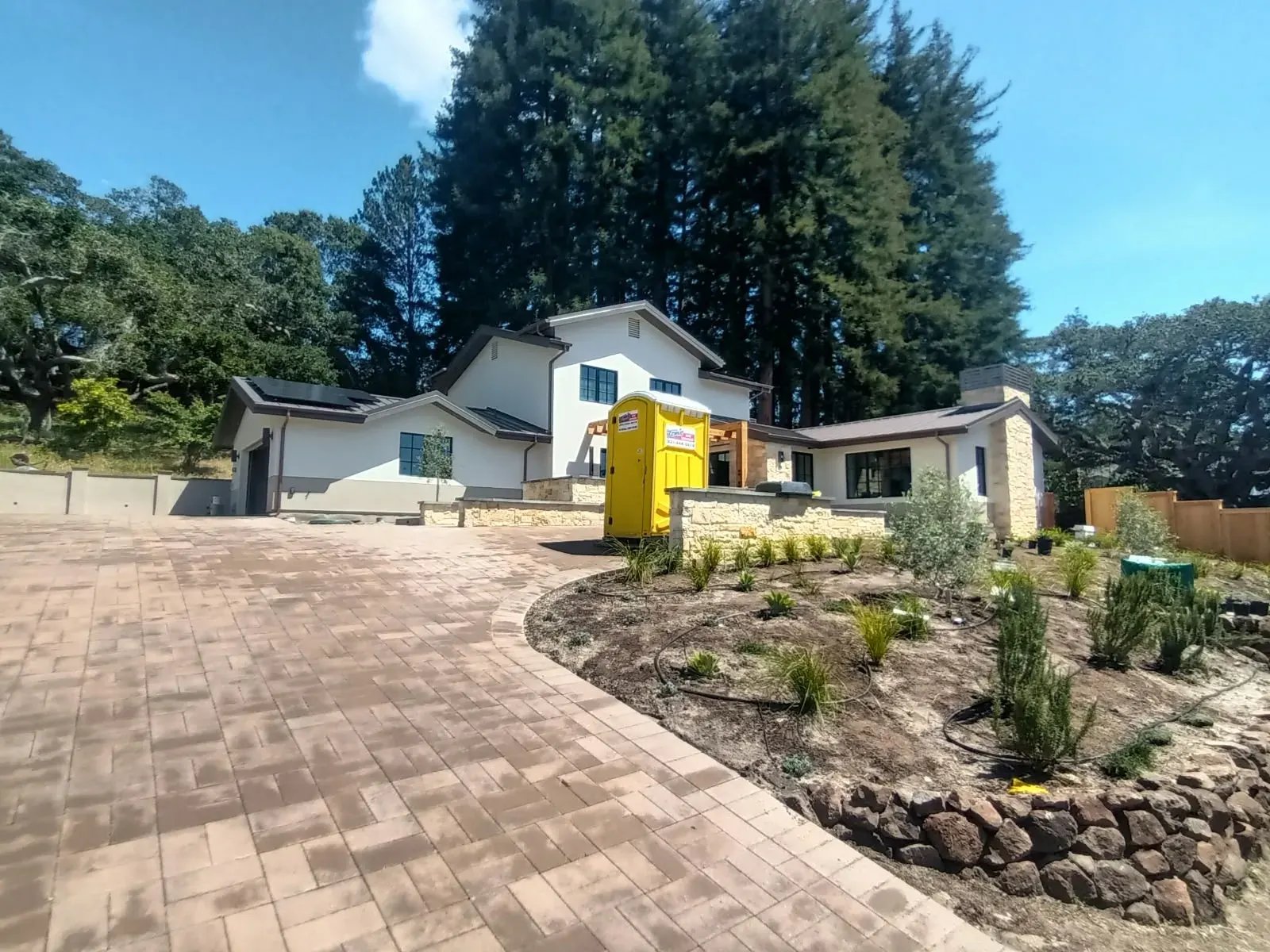 Exterior painting in Saratoga, CA: painted home among mature oak and redwood trees